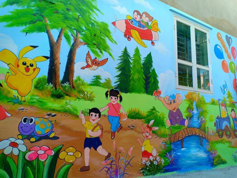 Một bức tường trường học cho thấy trẻ em chơi với những con vật dễ thương